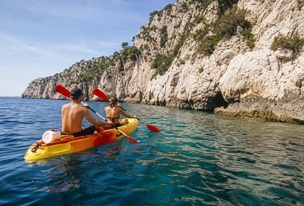Sea kayak beside a rocky island shore