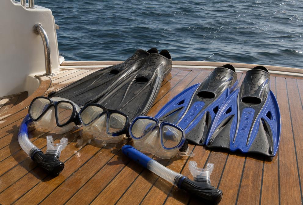Snorkel mask and fins on a yacht deck